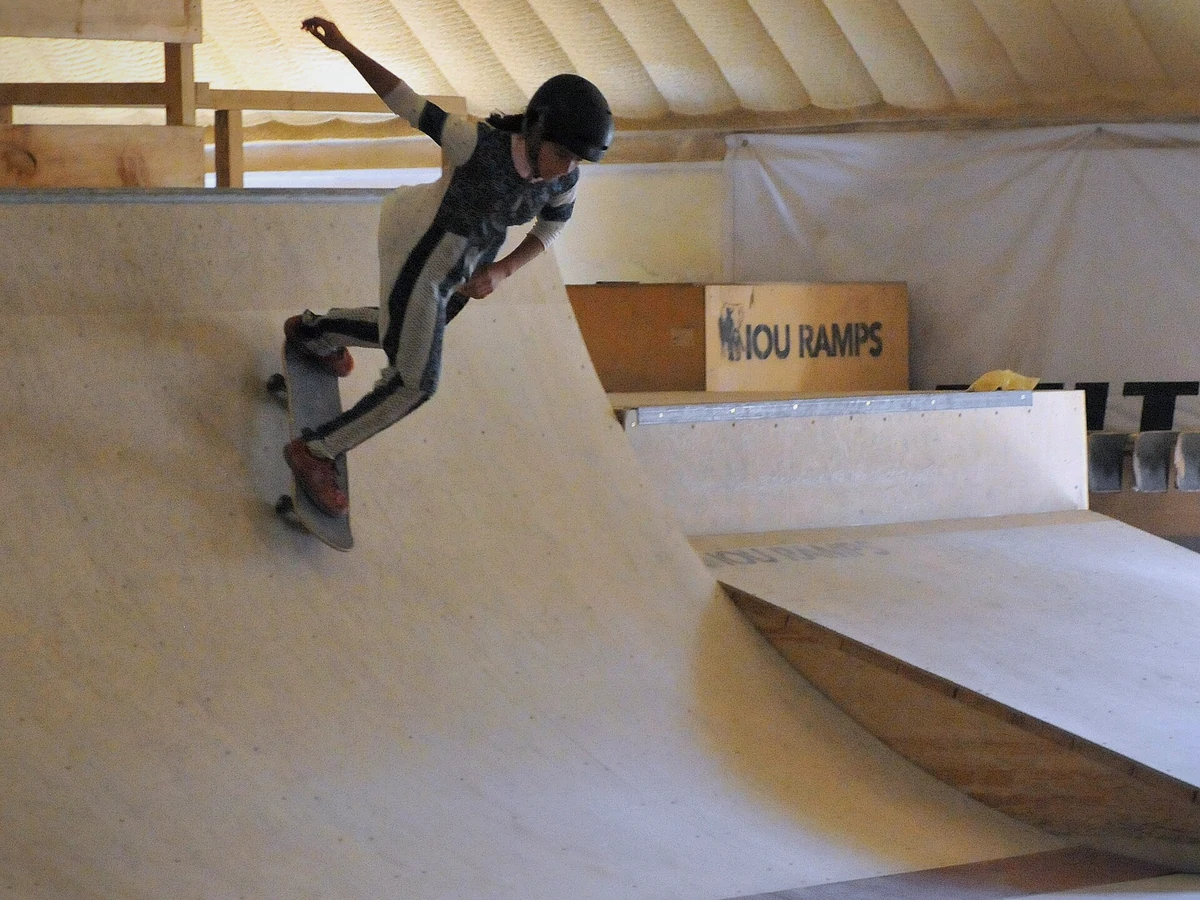 Skateboarder dropping into a ramp during a session